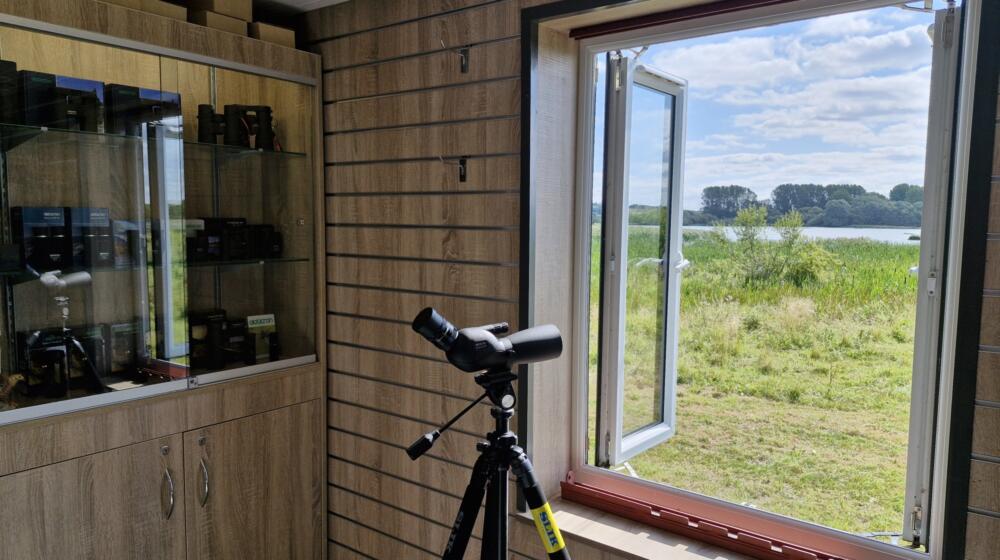An open window with a telescope in front at the In Focus optics shop at Rutland Water